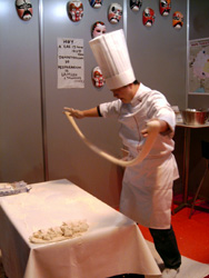 Chef chino estirando una masa hasta formar delgados hilos